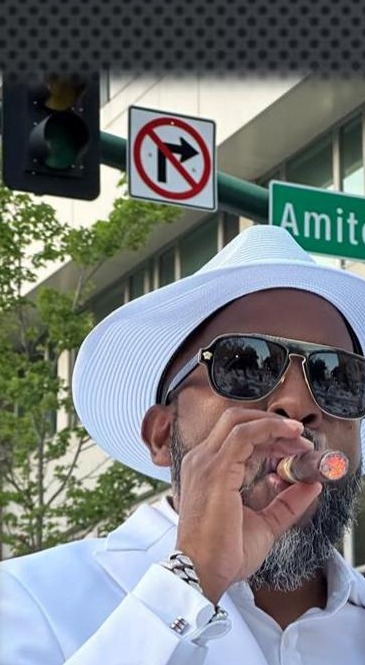 A member at Amite Street, in white linen, enjoying The Continental — Caton